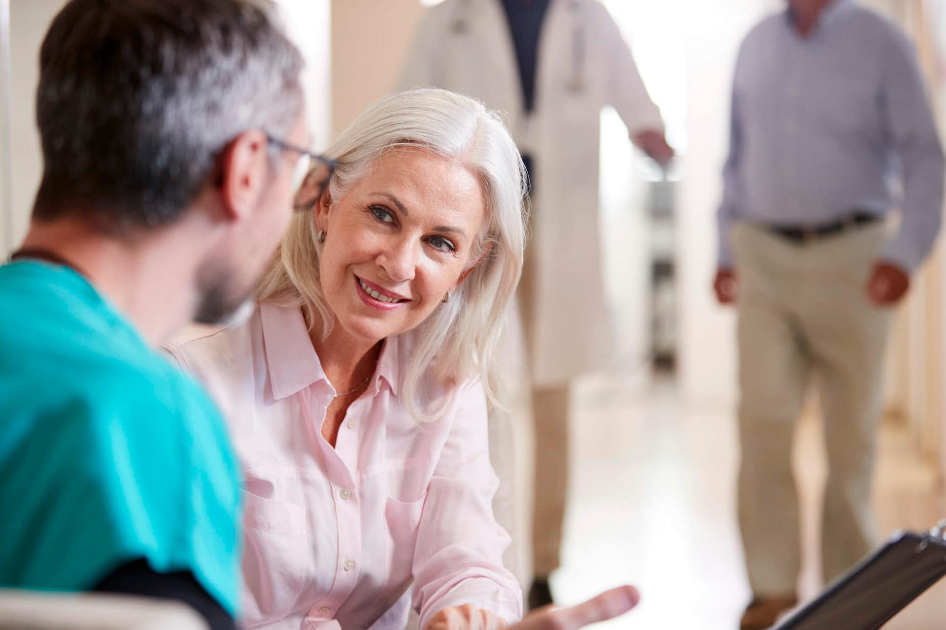 doctor-welcoming-to-senior-female-patient-being-ad-2021-08-26-16-15-24-utc-scaled