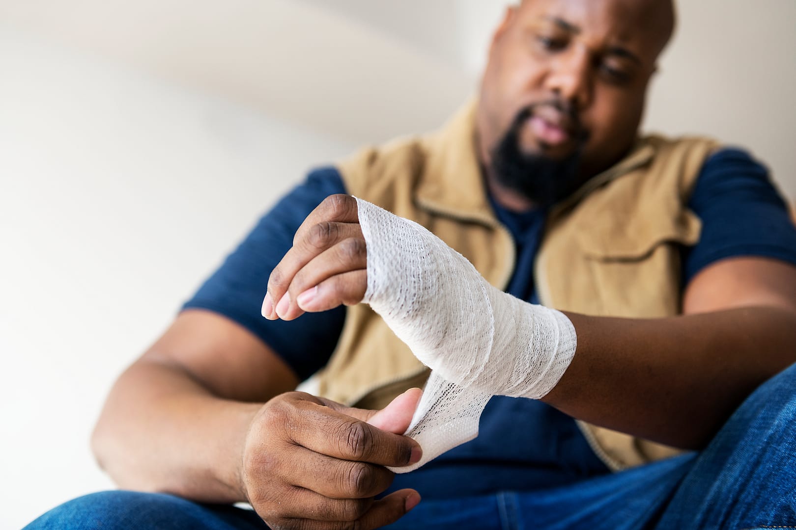 man-wrapping-his-injured-hand-with-bandage-2026-03-18-11-04-56-utc